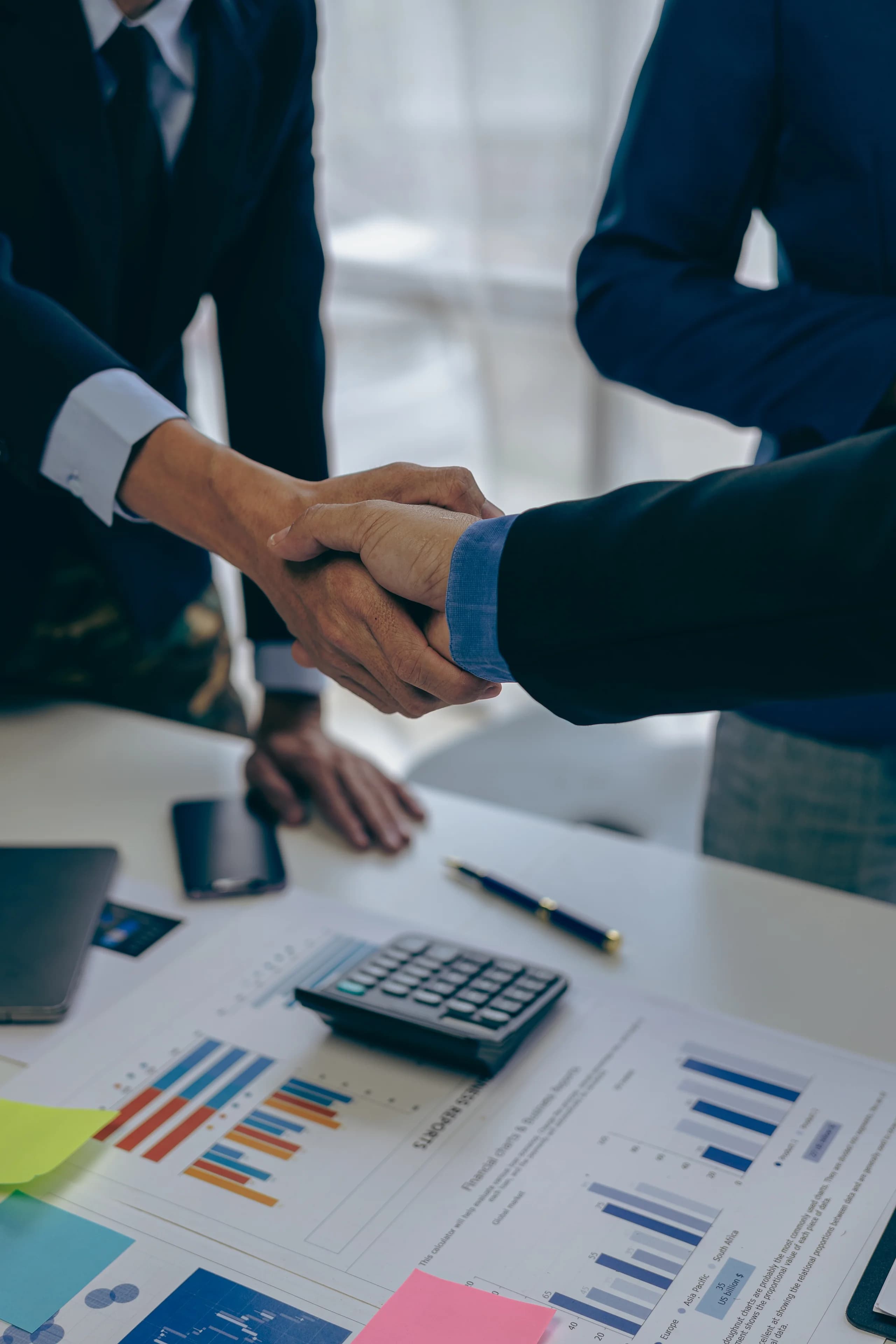 Business professionals shaking hands after an agreement