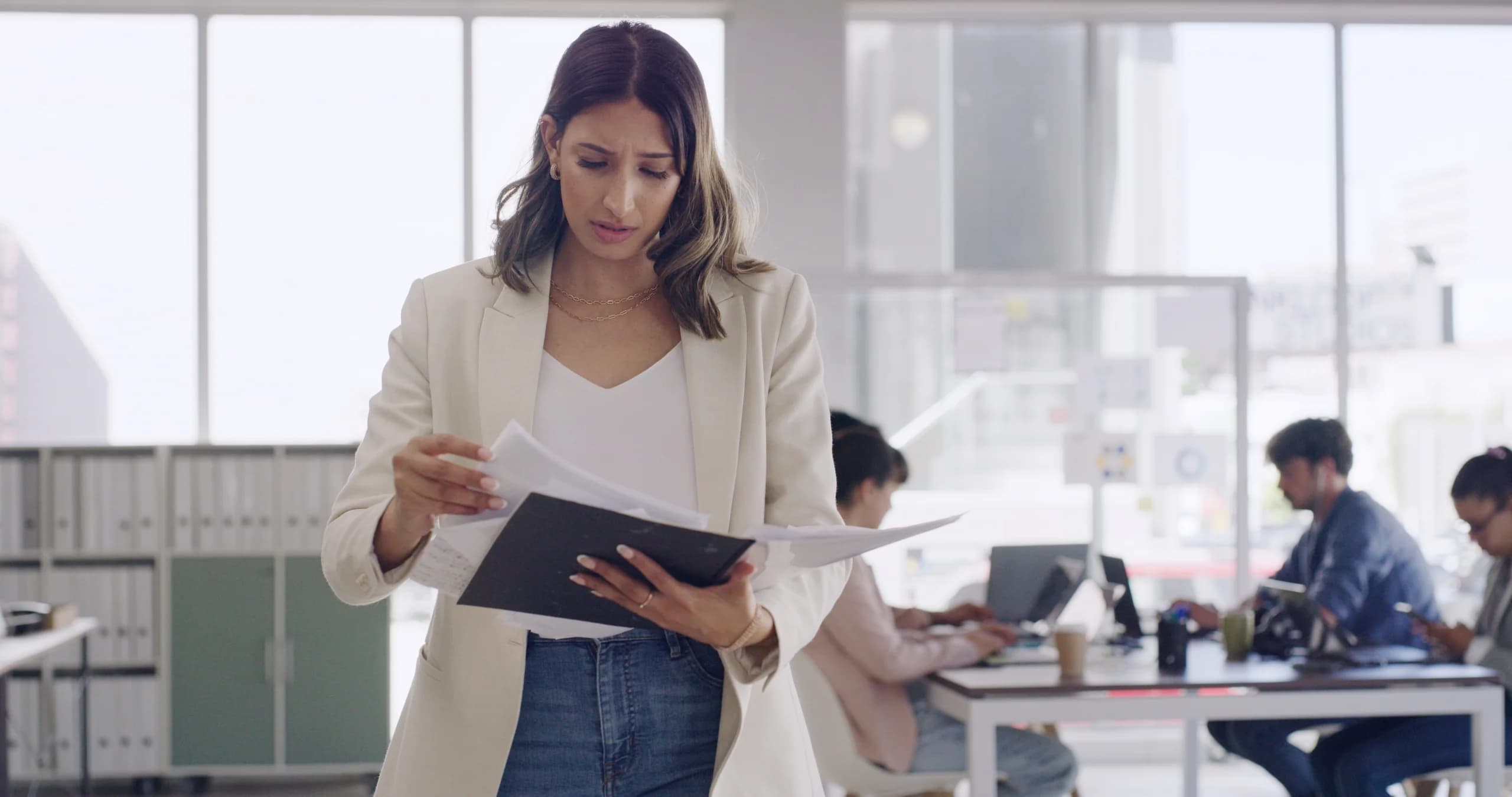 Audit and assurance professional holding reporting documents