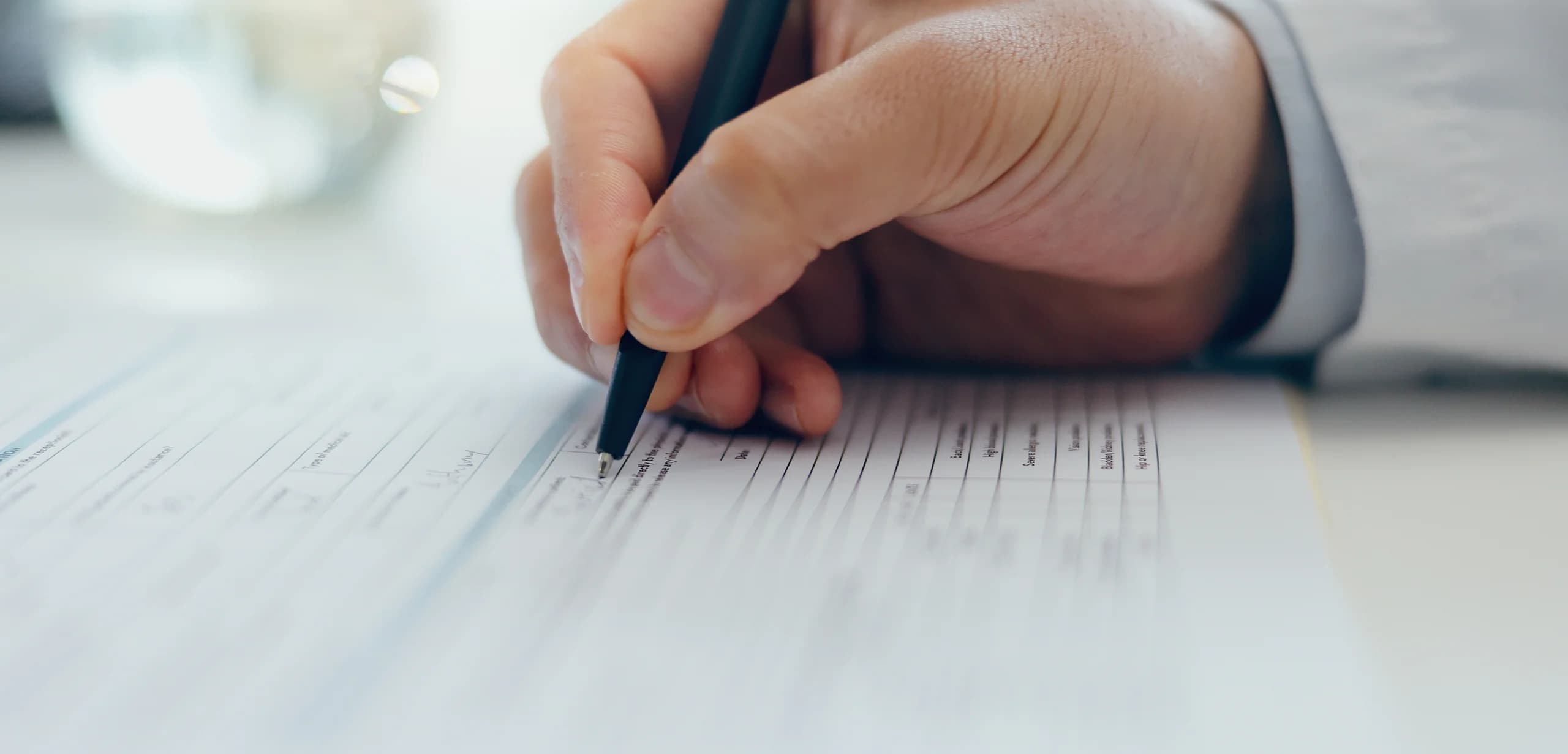Grant compliance document review and signature close-up