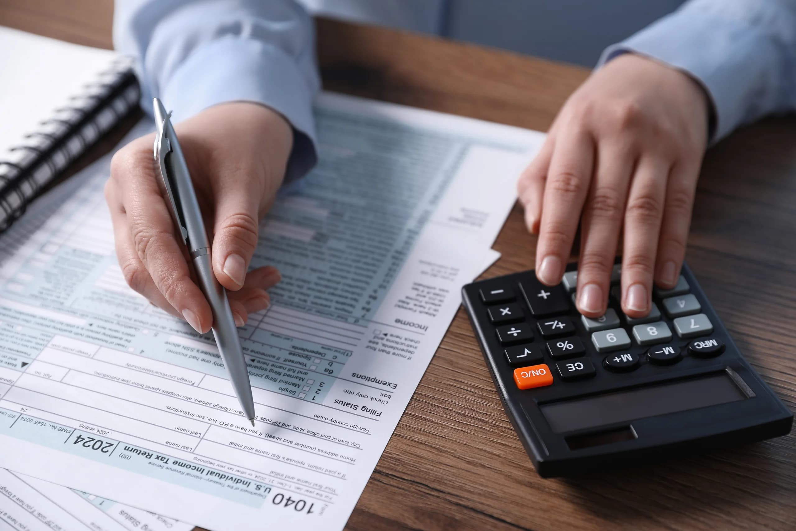 Calculator and tax documents used for compliance work