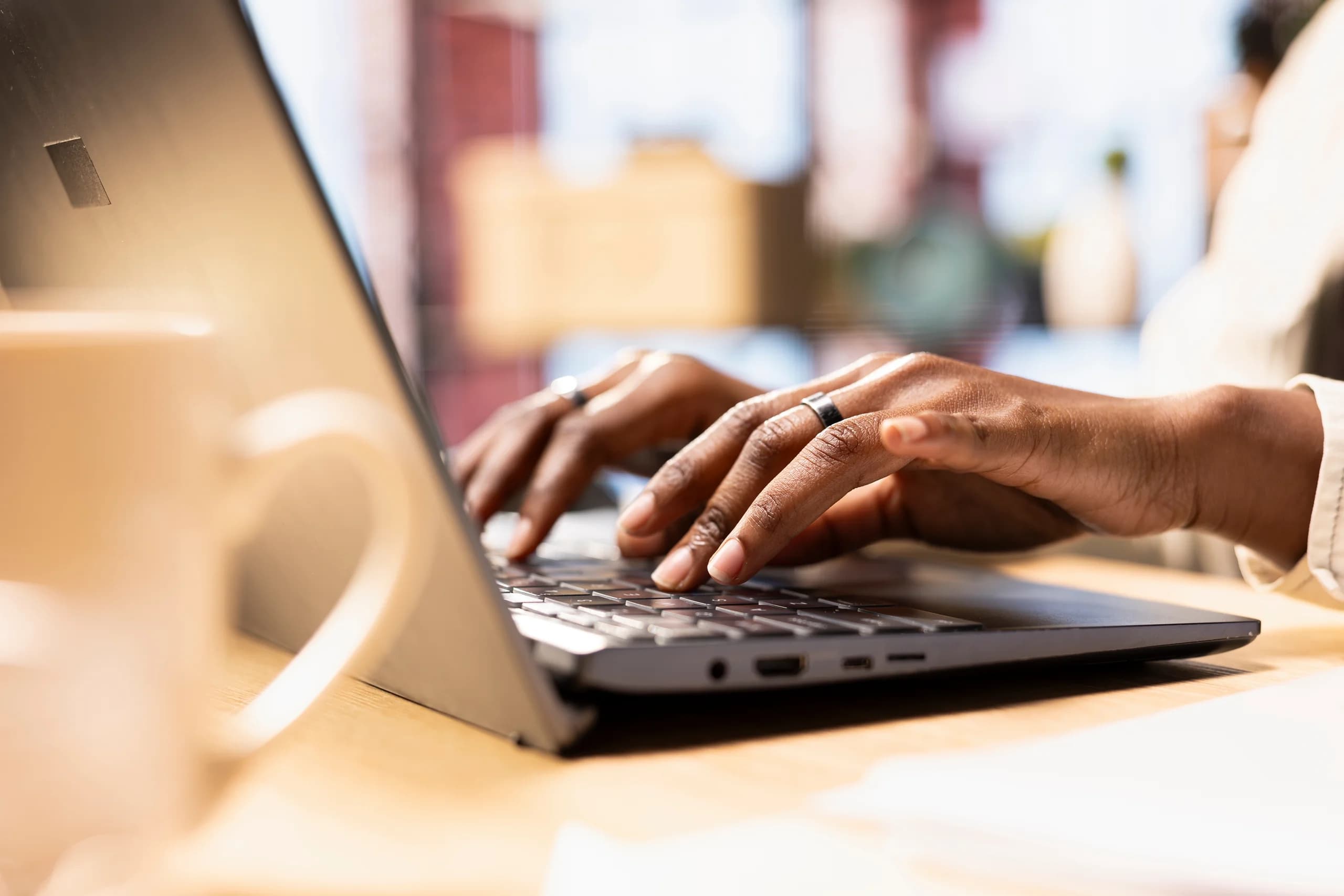 Hands working on a laptop for specialized tax research
