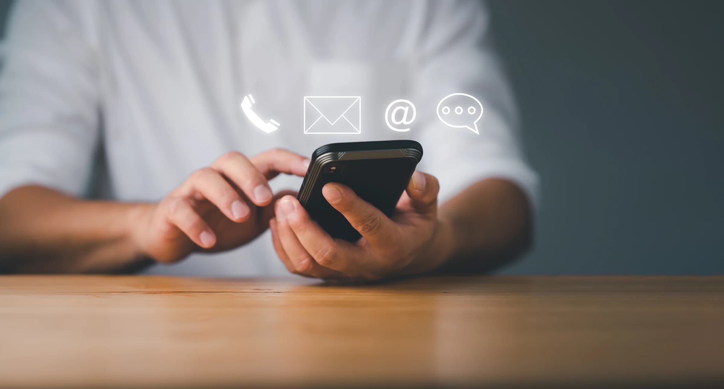 Person using a phone with contact and communication icons